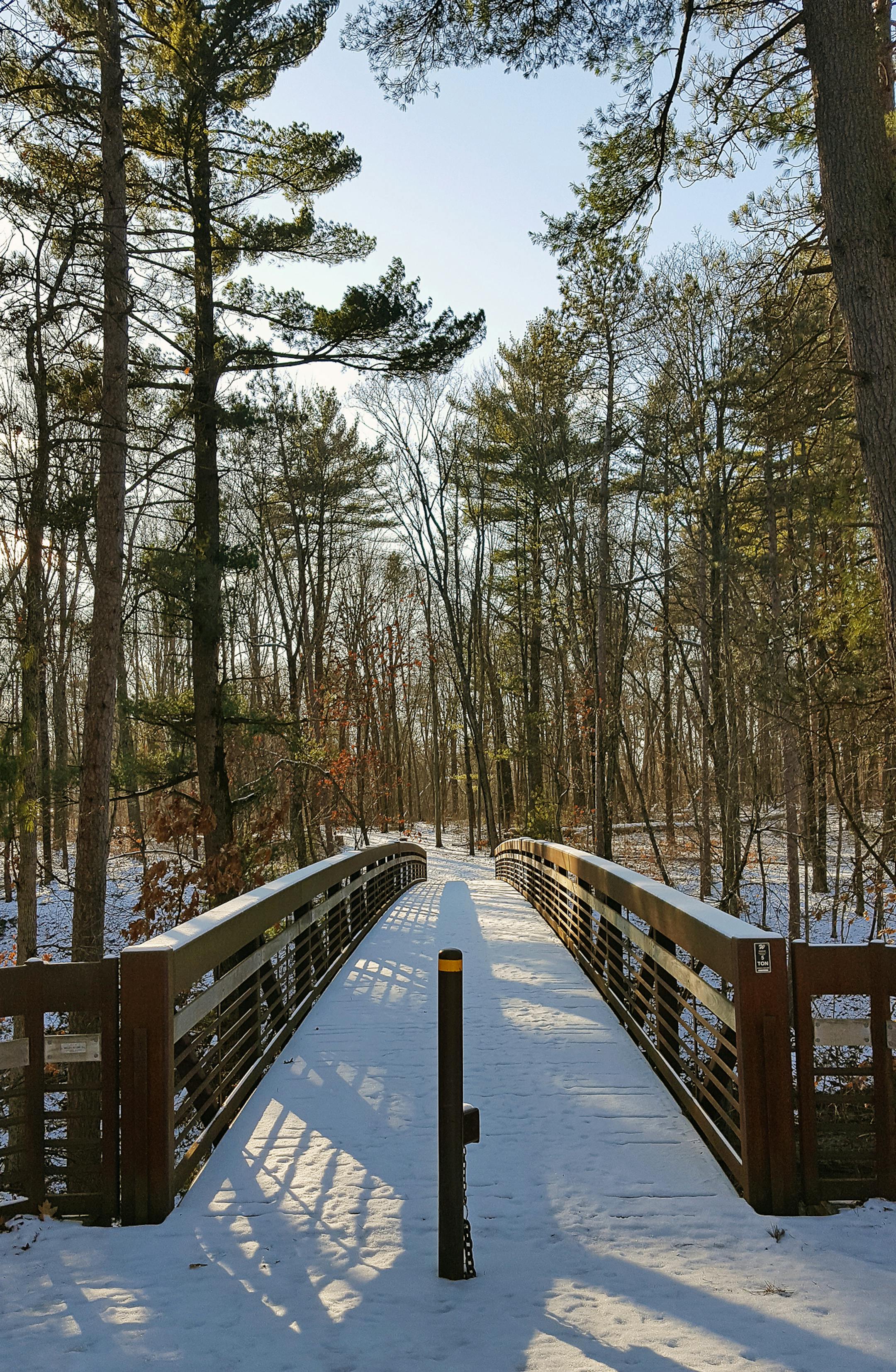 A footbridge connects the Ishnala Trail with the Echo Rock Trail in Mirror Lake State Park near Baraboo, above. It's a tight squeeze through the state park's Fern Dell Gorge, top.