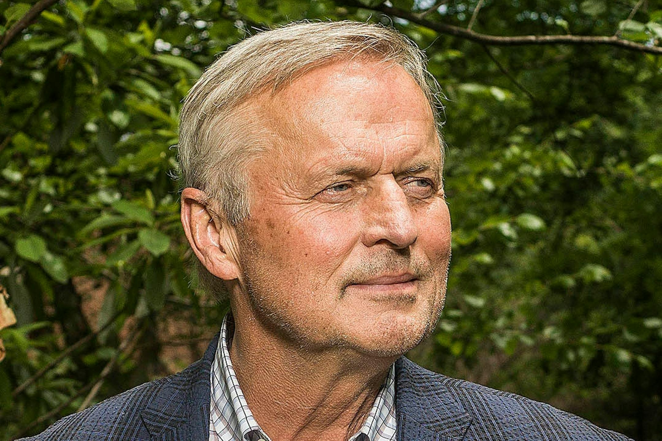 John Grisham, photographed in front of greenery