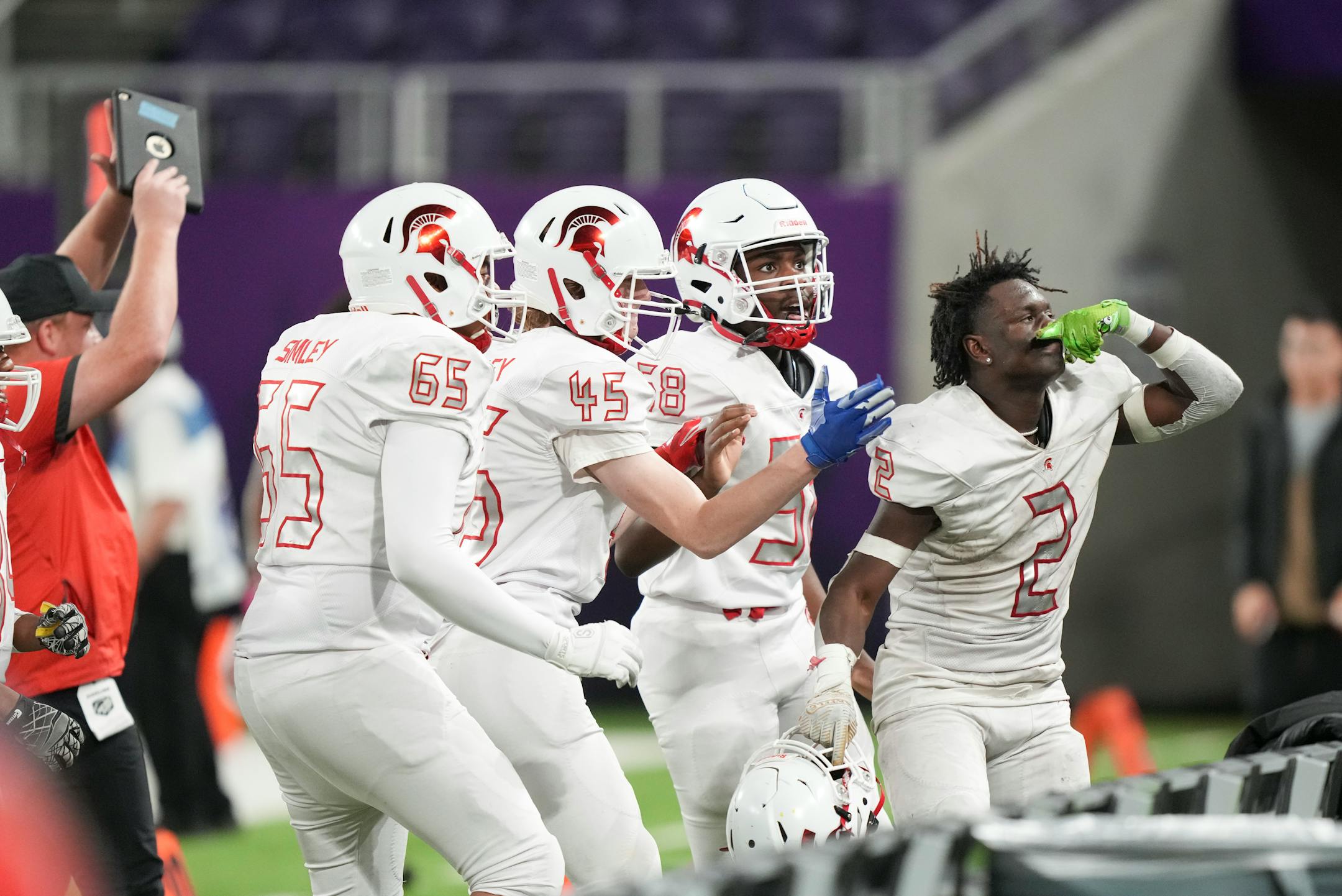 Simley Spartans wide receiver Tay'vion McCoy (2) gestures to the fan section after getting a interception and scoring in the second half.