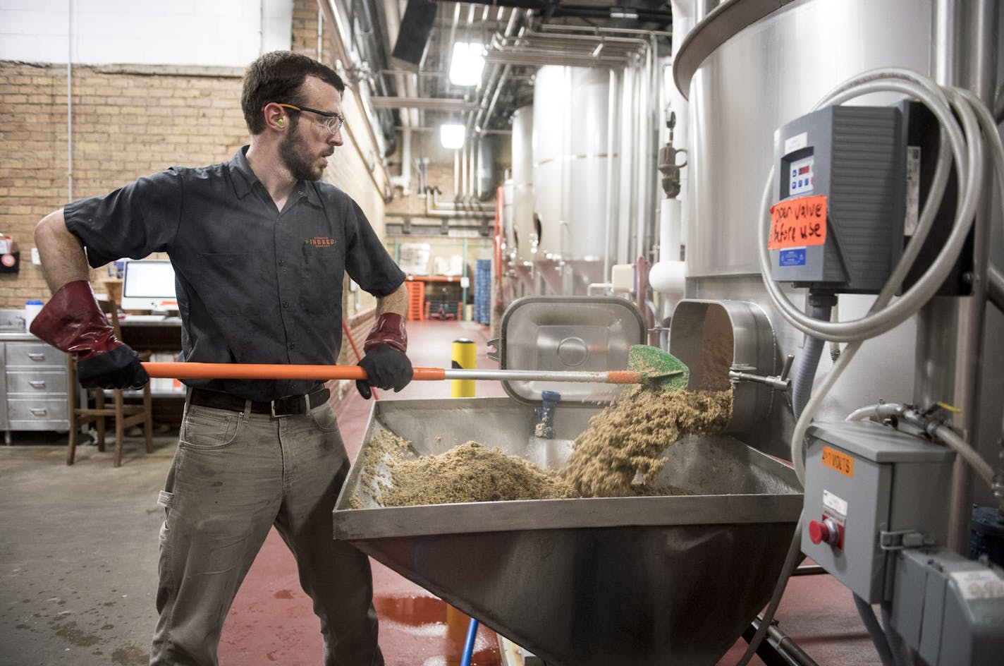 Dan Stavig, a brewer with Indeed Brewing Co. of Minneapolis, cleaned grain out of a mash tun that was used to make Dandy Lager one recent afternoon.