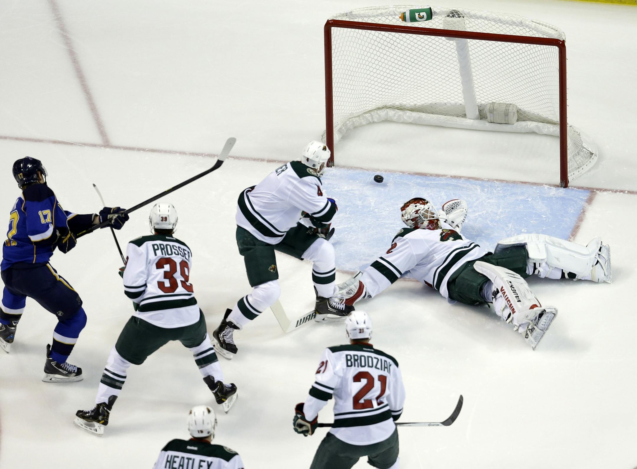 St. Louis Blues' Vladimir Sobotka, of the Czech Republic, scores past Minnesota Wild goalie Niklas Backstrom, of Finland; Kyle Brodziak (21); Clayton Stoner (4); and Nate Prosser (39) during the first period of an NHL hockey game Monday, Nov. 25, 2013, in St. Louis.