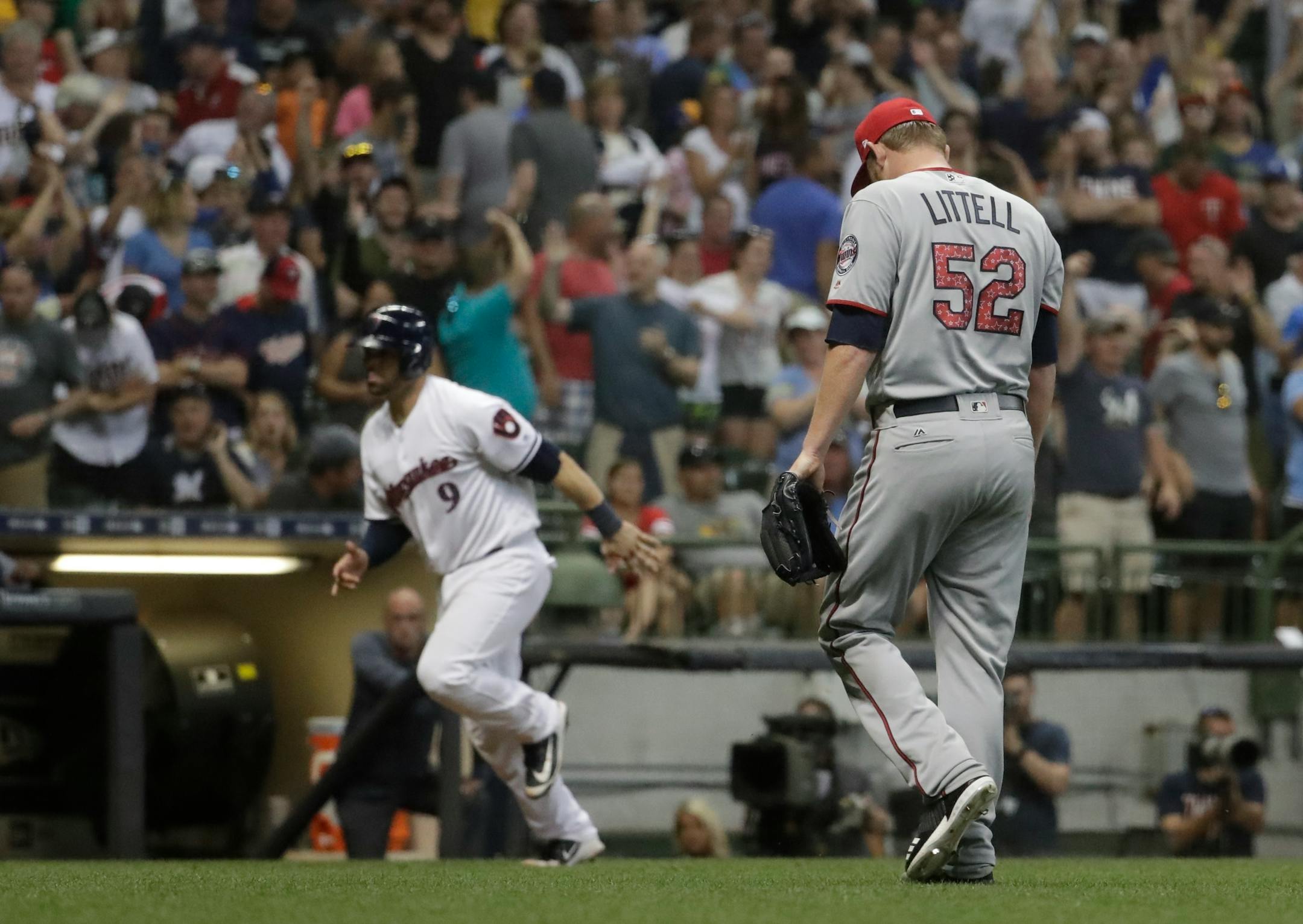 Twins reliever Zack Littell trudged back to the dugout as the Brewers' Manny Pina scored on a walkoff walk in the 10th inning Monday, giving Milwaukee a 6-5 victory.