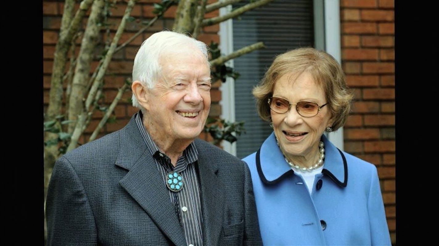 In this image from video, former President Jimmy Carter and former first lady Rosalynn Carter, seen in a photo as they speak on audio only, during the second night of the Democratic National Convention on Tuesday, Aug. 18, 2020.