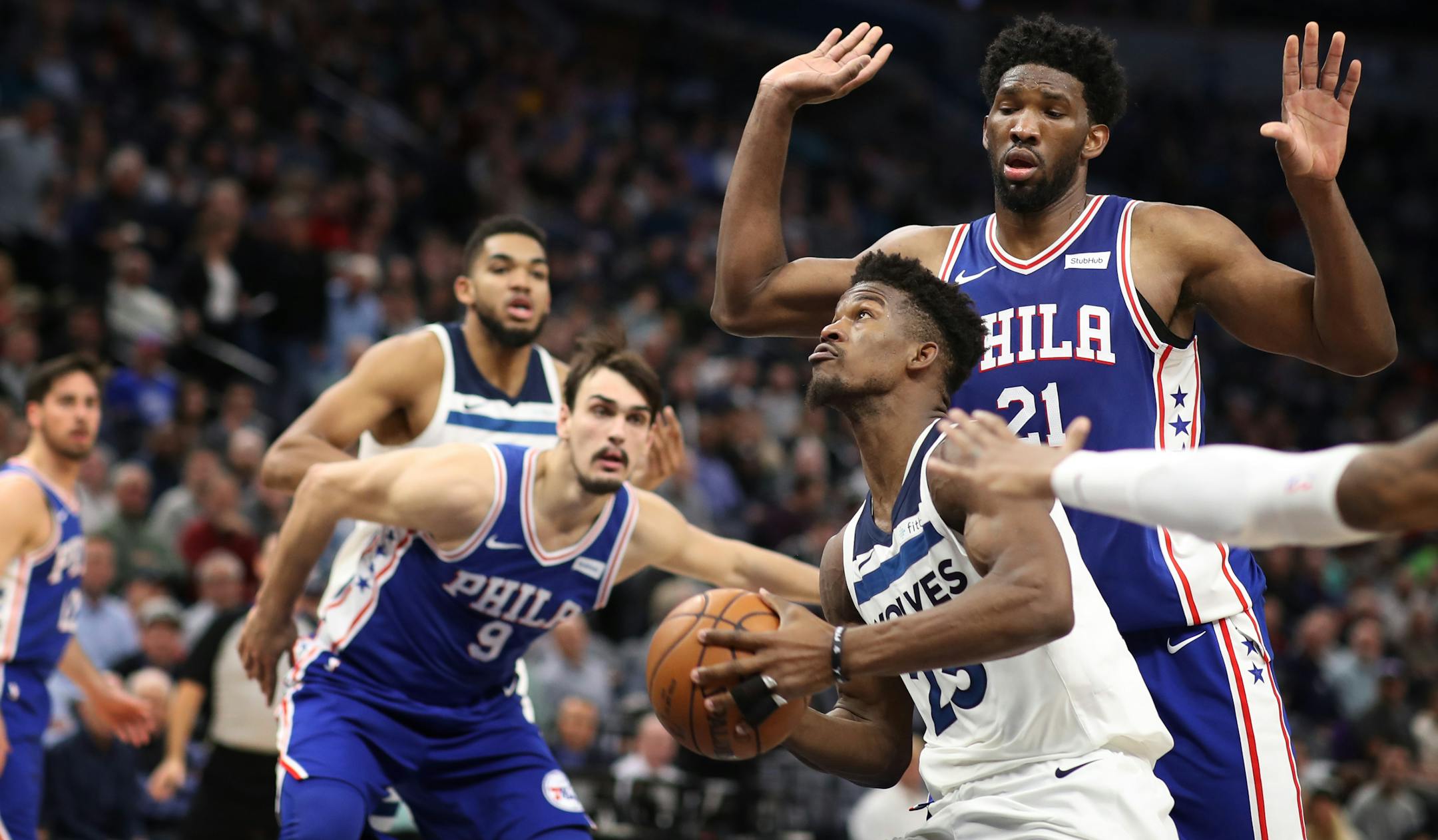 Minnesota Timberwolves guard Jimmy Butler (23) scored over Philadelphia 76ers center Joel Embiid (21) in the second half during NBA action at Target Center Tuesday December 12, 2017 in Minneapolis, MN.] The Minnesota Timberwolves hosted the Philadelphia 76ers at Target Center. JERRY HOLT � jerry.holt@startribune.com