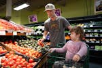 Josh Kohanek and Rudy, 4, pick up groceries at Seward Community Co-op in Minneapolis on May 7.