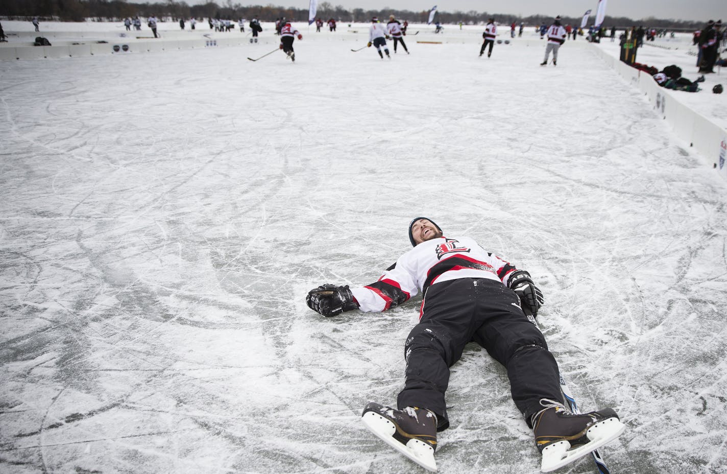 Steve Barrett of the Louisville, Ky. based team the Kentucky Gentlemen lays on the ice after winning a scrimmage during the U.S. Pond Hockey Championships at Lake Nokomis in Minneapolis on Friday, January 16, 2015. ] LEILA NAVIDI leila.navidi@startribune.com /