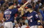 Minnesota Twins relief pitcher Brandon Kintzler (27) and second baseman Brian Dozier (2) celebrate after the Twins defeated the Boston Red Sox 2-1 in 