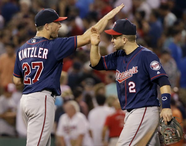 Minnesota Twins relief pitcher Brandon Kintzler (27) and second baseman Brian Dozier (2) celebrate after the Twins defeated the Boston Red Sox 2-1 in 
