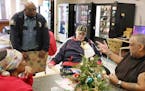 St. Paul police officer Greg Williams talked with a group of residents including Craig Schusbel, center, during breakfast.
