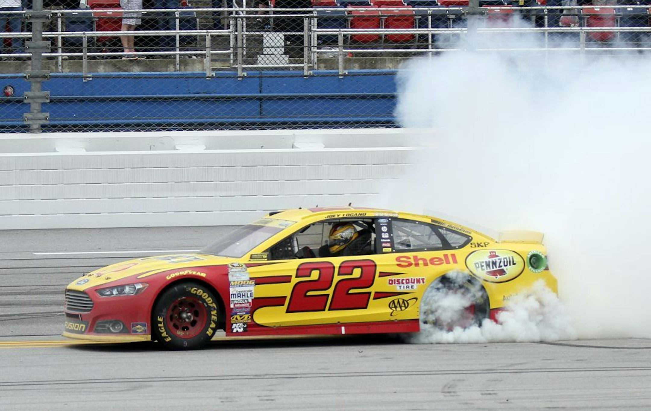 Sprint Cup Series driver Joey Logano (22) smokes his tires after winning the NASCAR Sprint Cup Series auto race at Talladega Superspeedway Sunday, Oct. 25, 2015, in Talladega, Ala.