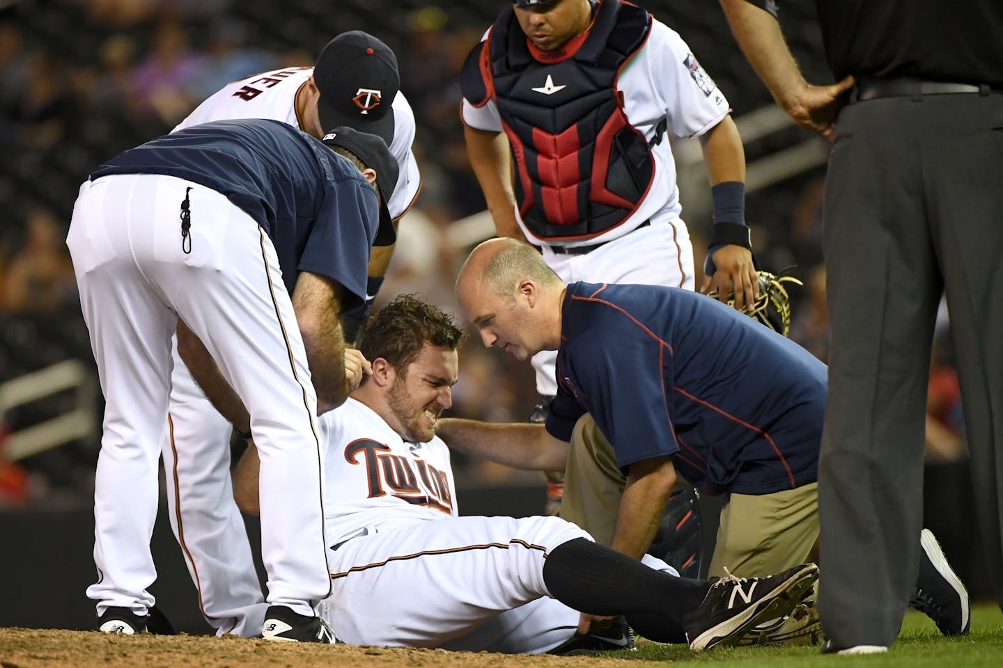 Minnesota Twins starting pitcher Phil Hughes (45) was helped off the field after taking a sharp line drive to the knee by Miami Marlins catcher J.T. Realmuto (11) in the top of the 9th inning.