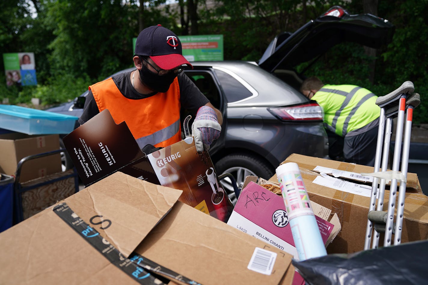 ARC Value Village donation center support employees Andrew Harmer, left, and Erik Westenfield unloaded items to be donated from a vehicle Thursday morning. ] ANTHONY SOUFFLE • anthony.souffle@startribune.com ARC Value Village donation center employees worked to keep up with the steady stream of cars packed full of items to be donated from people cleaning out their homes during the Stay Home Minnesota order to prevent the spread of COVID-19 Thursday, May 28, 2020 in Richfield, Minn. The resale st