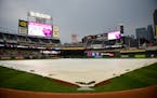 A rain tarp was rolled out over the infield during a rain delay before the start of the Twins game against the Cleveland Indians.