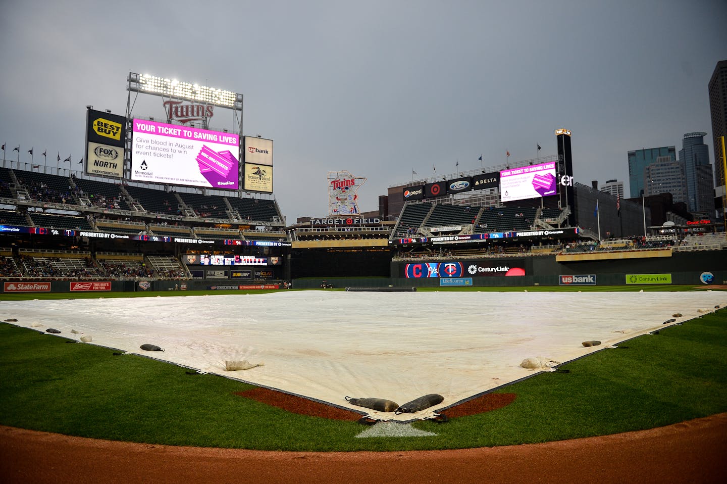 A rain tarp was rolled out over the infield during a rain delay before the start of the Twins game against the Cleveland Indians.