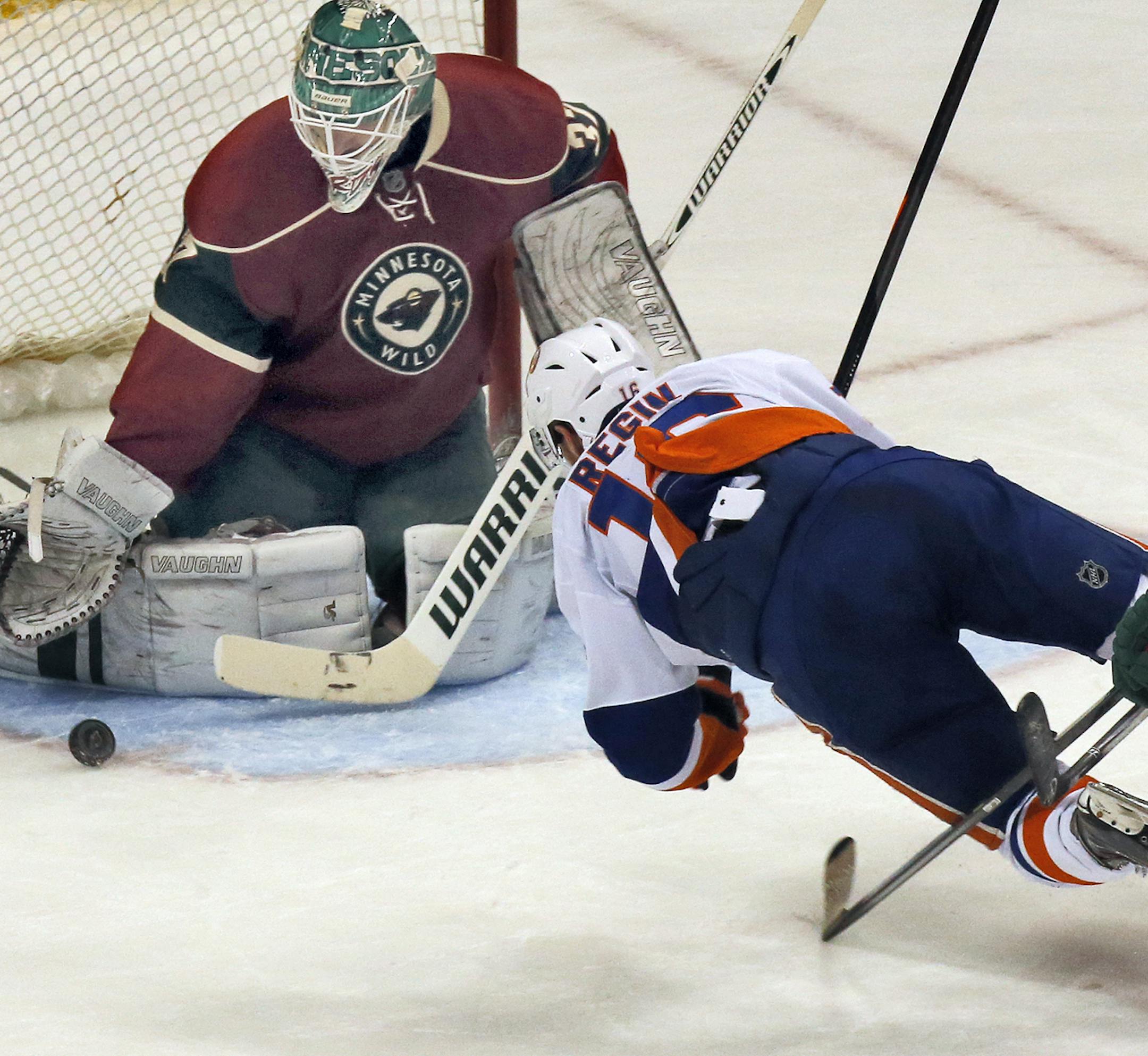 Minnesota Wild vs. New York Islanders. Islanders Peter Regin was sent flying by the Wild defense as he attempted a shot on goal against Wild goalie Josh Harding. (MARLIN LEVISON/STARTRIBUNE(mlevison@startribune.com)