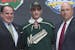 Scout Craig Channell, Luke Kunin and Wild assistant GM Brent Flahr posed after the Wisconsin forward put on a Wild sweater at the NHL draft on Friday 