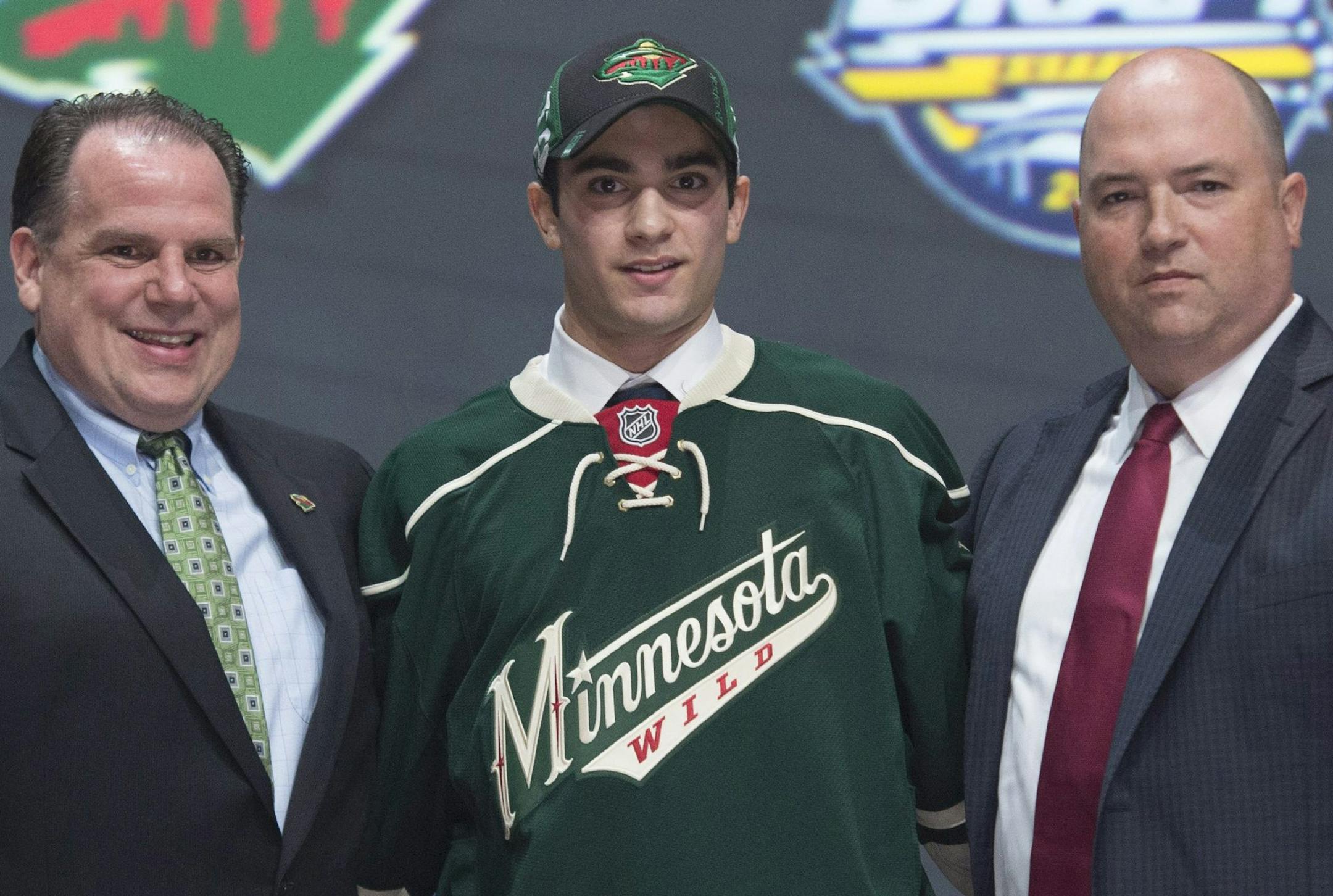 Scout Craig Channell, Luke Kunin and Wild assistant GM Brent Flahr posed after the Wisconsin forward put on a Wild sweater at the NHL draft on Friday night in Buffalo, N.Y.