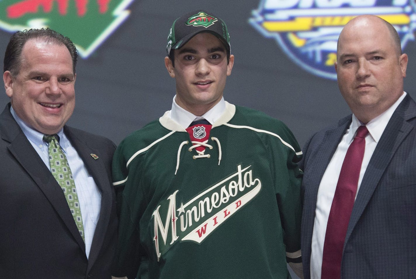 Scout Craig Channell, Luke Kunin and Wild assistant GM Brent Flahr posed after the Wisconsin forward put on a Wild sweater at the NHL draft on Friday night in Buffalo, N.Y.