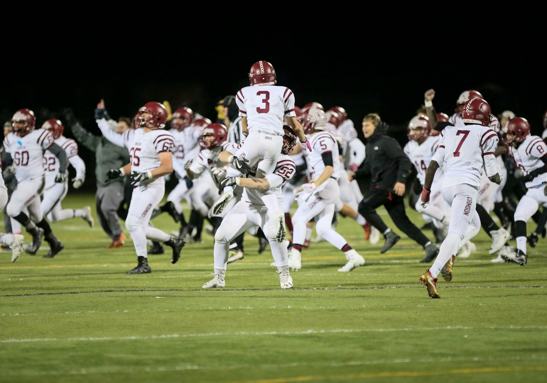 Maple Grove players Jake Kampsula (3) leapt into Ben Bristol's arms as they celebrated an incredible comeback win against St. Michael-Albertville 29-27. ] RENEE JONES SCHNEIDER • renee.jones@startribune.com Class 6A quarterfinals between St. Michael-Albertville and Maple Grove on Thursday, November 9, 2017, in Brooklyn Park, Minn.