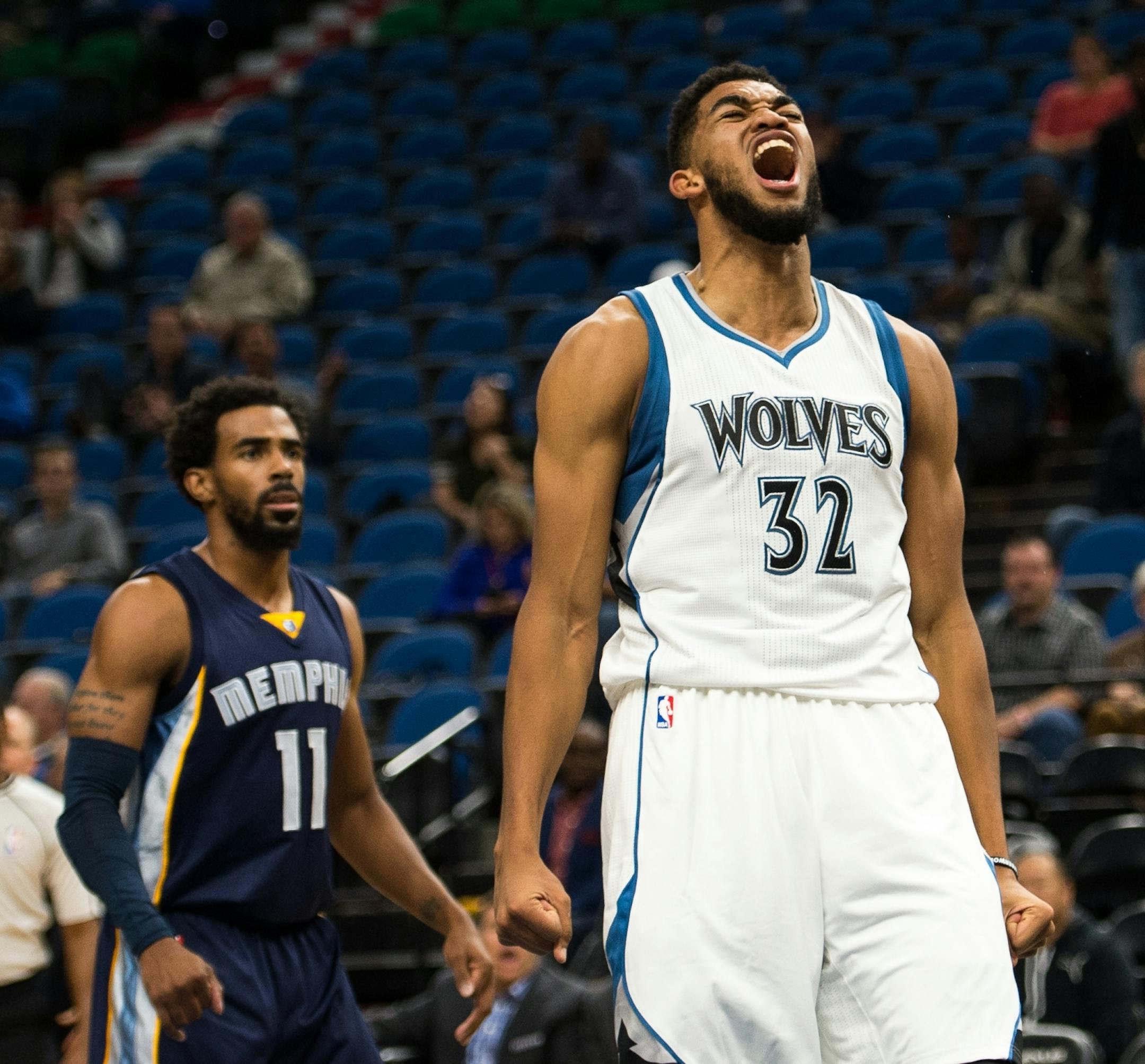 Minnesota Timberwolves forward Karl-Anthony Towns (32) let out a roar after dunking in the first quarter against the Memphis Grizzlies.