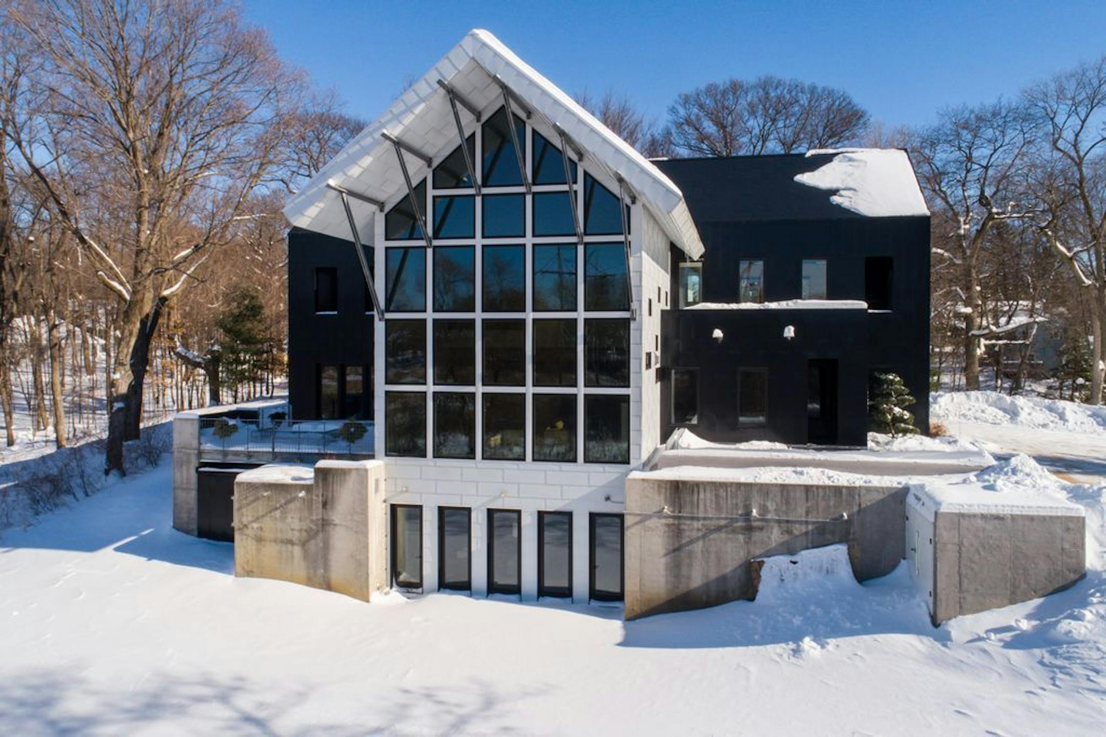 A soaring wall of glass on one side of the house.