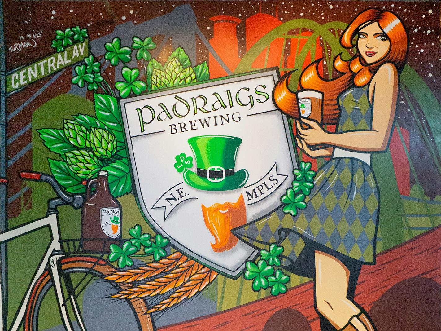 Updated mural by local artist Adam Turman showing a woman holding a beer for Padraigs Brewery in northeast Minneapolis.