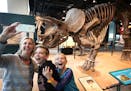 Michelle Shirley of Eden Prairie and her children William, 12 and Ava, 9, take a selfie with triceratops at the Science Museum of Minnesota Tuesday af