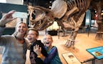 Michelle Shirley of Eden Prairie and her children William, 12 and Ava, 9, take a selfie with triceratops at the Science Museum of Minnesota Tuesday af