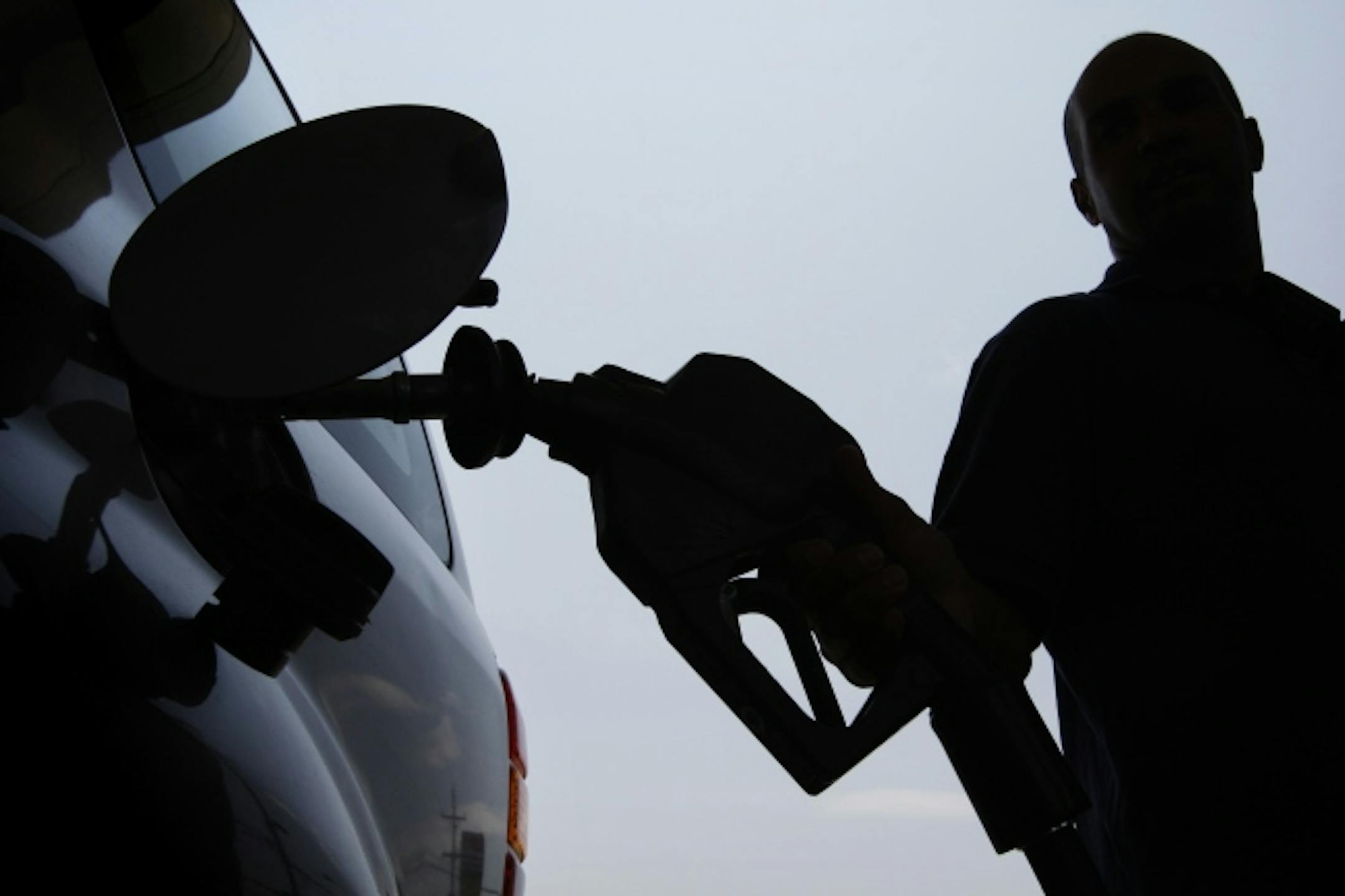 In this June 27, 2008 file photo, a person pulls a gas pump from his vehicle after filling his tank in Philadelphia. While the return of $100 oil is being greeted as relatively good news for consumers, the jarring reality of $4-a-gallon gasoline stirred up an unprecedented level of consumer angst that experts say will keep people from reverting to extravagant energy use for years to come _ if ever again.