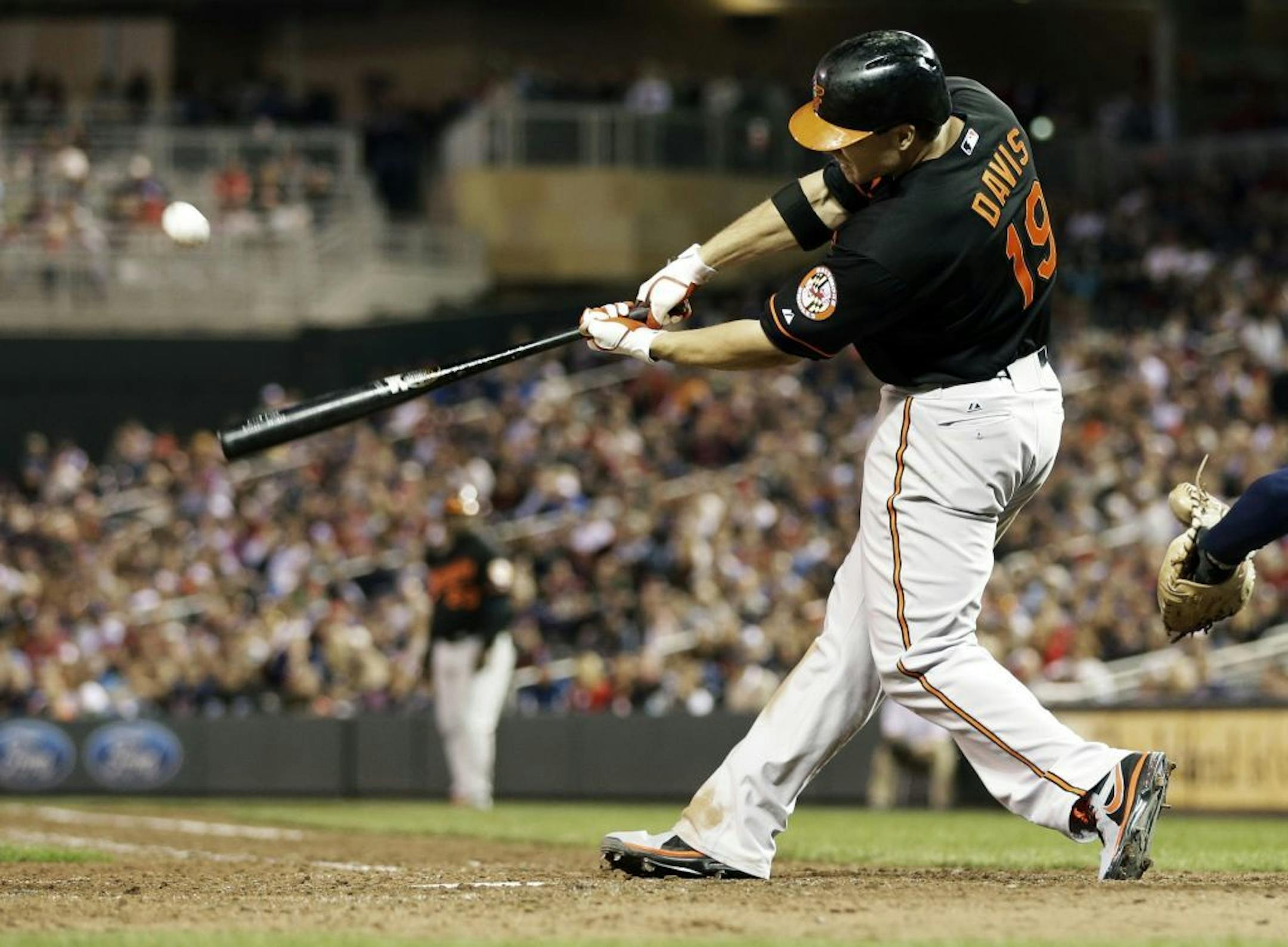 Baltimore Orioles' Chris Davis connects with an RBI-double to tie the game off a pitch from Minnesota Twins' Josh Roenicke in the seventh inning of a baseball game on Friday, May 10, 2013, in Minneapolis.