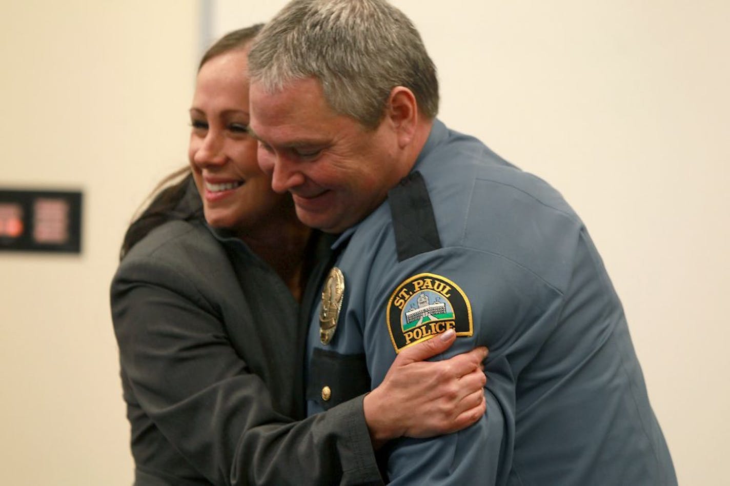 Sarah Meggitt hugged officer John McManus before they were honored for helping to save the life of a suicidal woman.