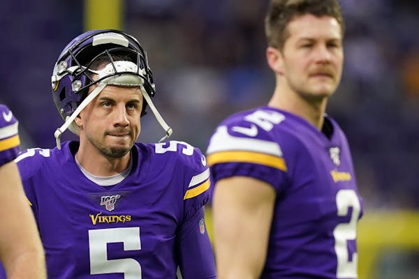 Minnesota Vikings kicker Dan Bailey (5) watched warmups along with punter Britton Colquitt (2) ahead of Sunday's game against the Chicago Bears. ] ANT