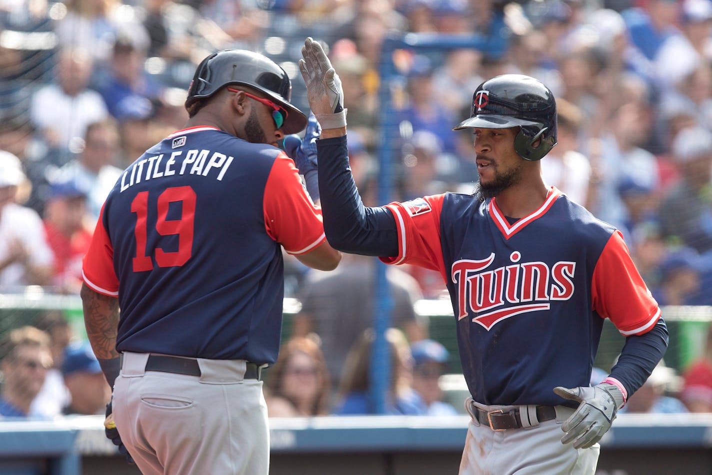 Minnesota Twins' Byron Buxton, right, is congratulated by Kennys Vargas as he crosses home plate after hitting a solo home run off Toronto Blue Jays relief pitcher Tim Mayza during the ninth inning of baseball game action in Toronto, Sunday, Aug. 27, 2017. (Chris Young/The Canadian Press via AP)