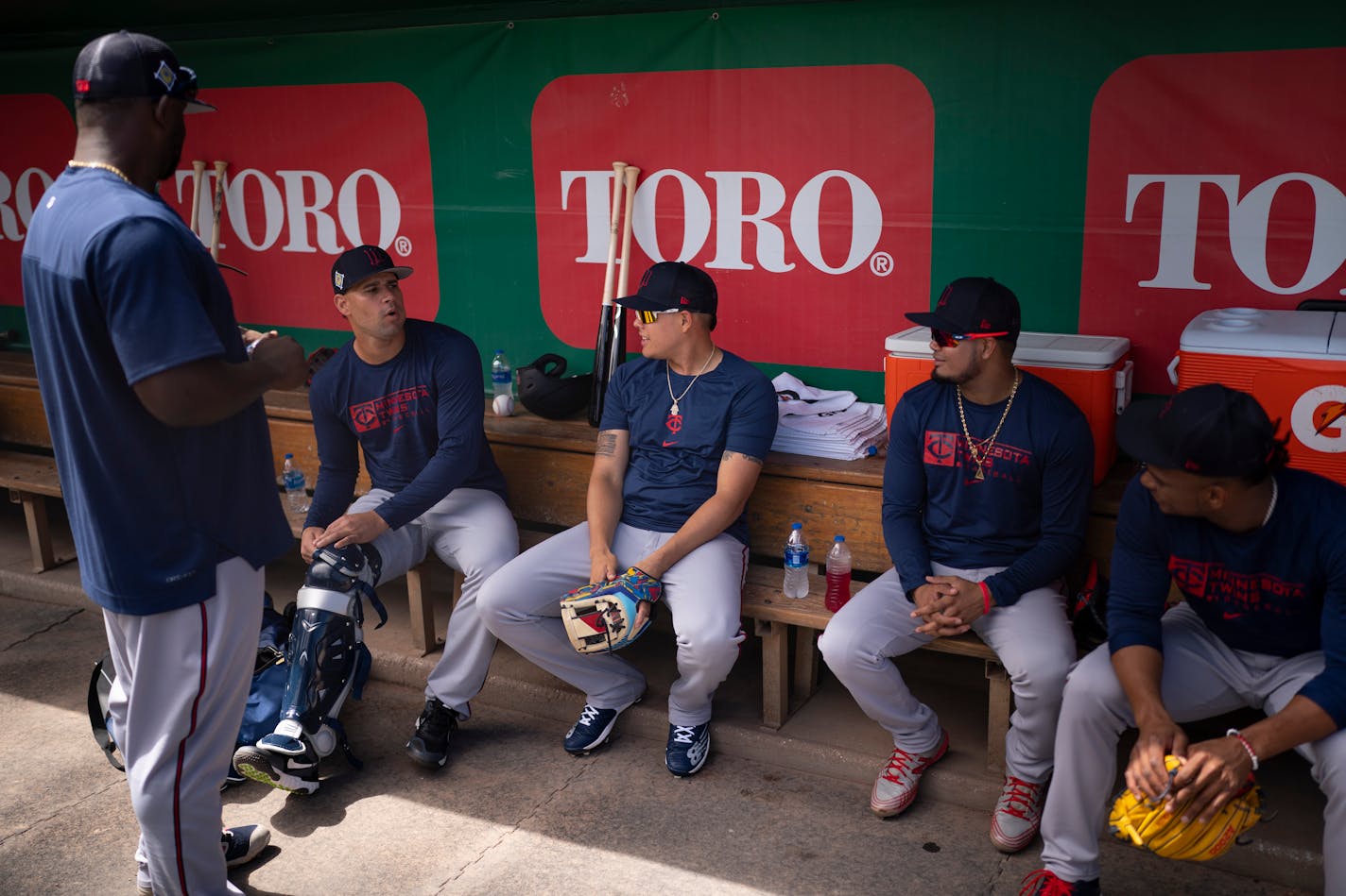 Gary Sanchez, second from left, chatted with his former Yankee teammate, Gio Urshela, and his new Twins teammates, Luis Arraez and Jorge Polanco, right, in the dugout before a drill began at Hammond Stadium in Fort Myers, Florida Monday, March 14, 2022. Miguel Sano was standing at left. After some late night roster moves, the Twins full squad reported to Spring Training for Monday's workout. ] JEFF WHEELER • Jeff.Wheeler@startribune.com