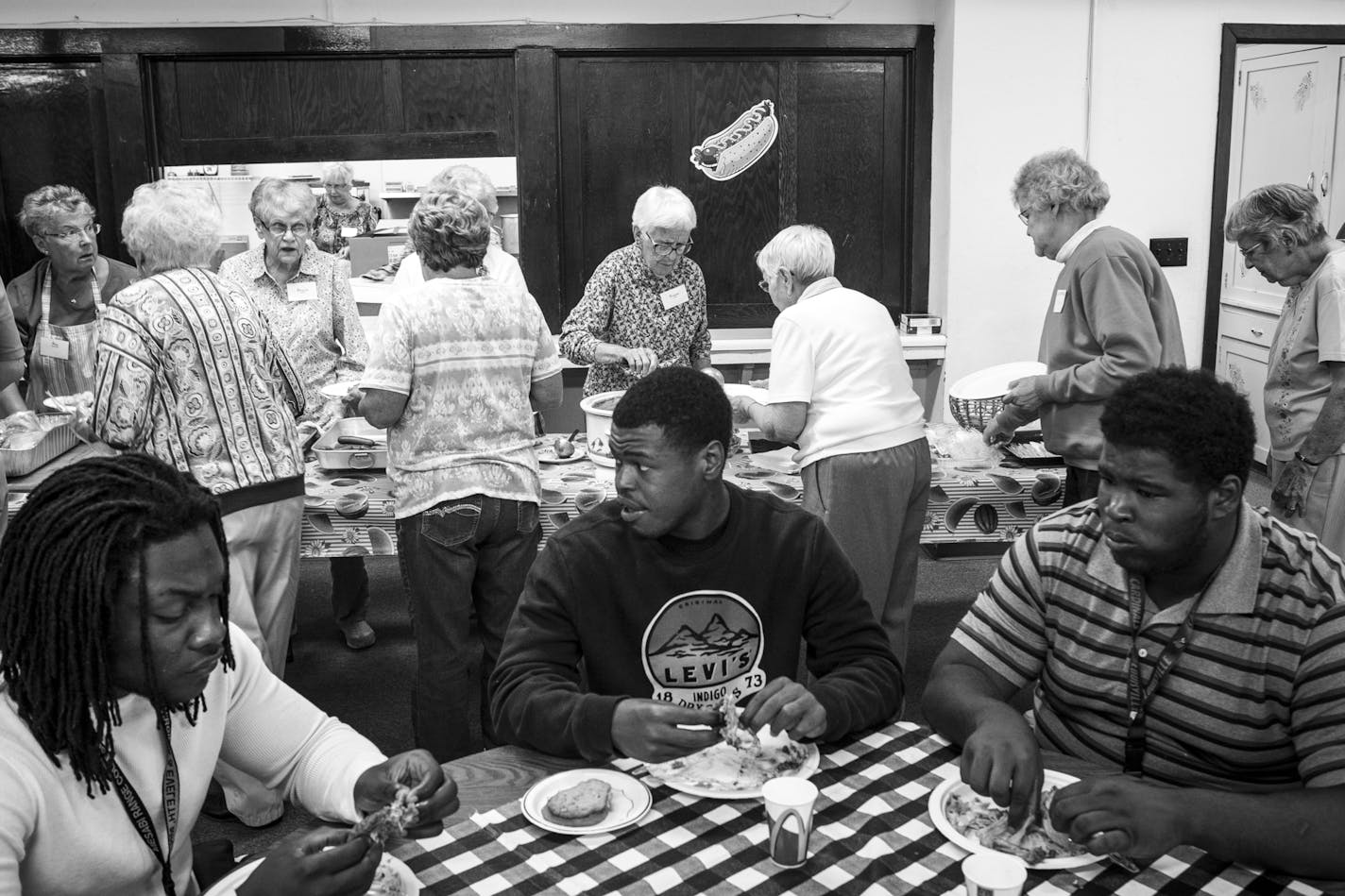 From left, linebacker Elvin Turner, receiver Shaheem Sanders and lineman Uriah English ate lunch in the basement of Hope Community Presbyterian Church in late August as church volunteers served themselves after feeding the team. ] Aaron Lavinsky &#x2022; aaron.lavinsky@startribune.com Photos to accompany a story on the Mesabi Range College Football team in Virginia, Minnesota. The team, which consists mostly of black athletes recruited from around the country, struggles to find its place in most