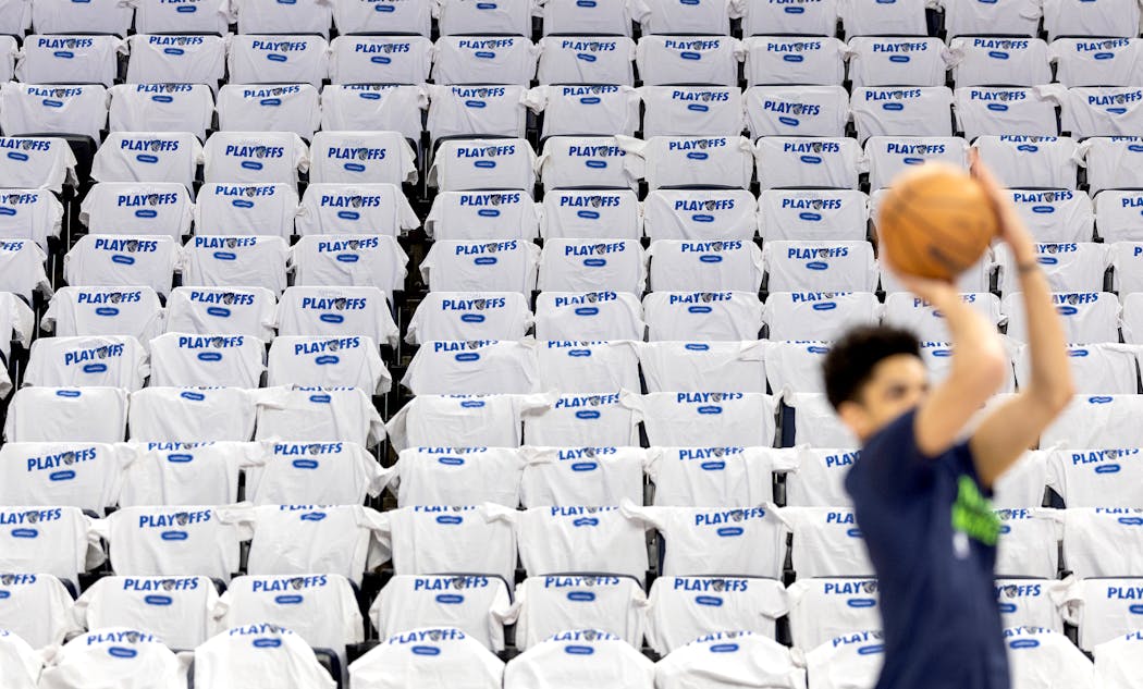 NBA playoff shirts were placed on seats at Target Center as Josh Minott of the Timberwolves warmed up before Game 1 on Saturday.