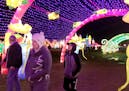 Visitors to the Lantern Light Festival in Shakopee pass through a walkway covered in lights and lanterns.
