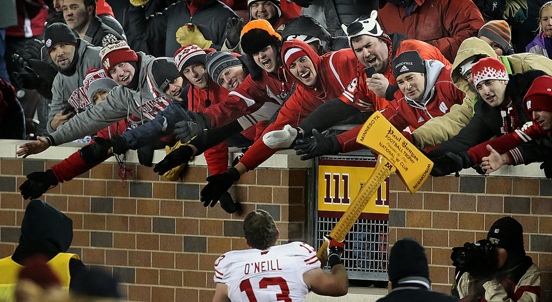Wisconsin players ran around the field with Paul Bunyan's Axe after beating Minnesota on Saturday.