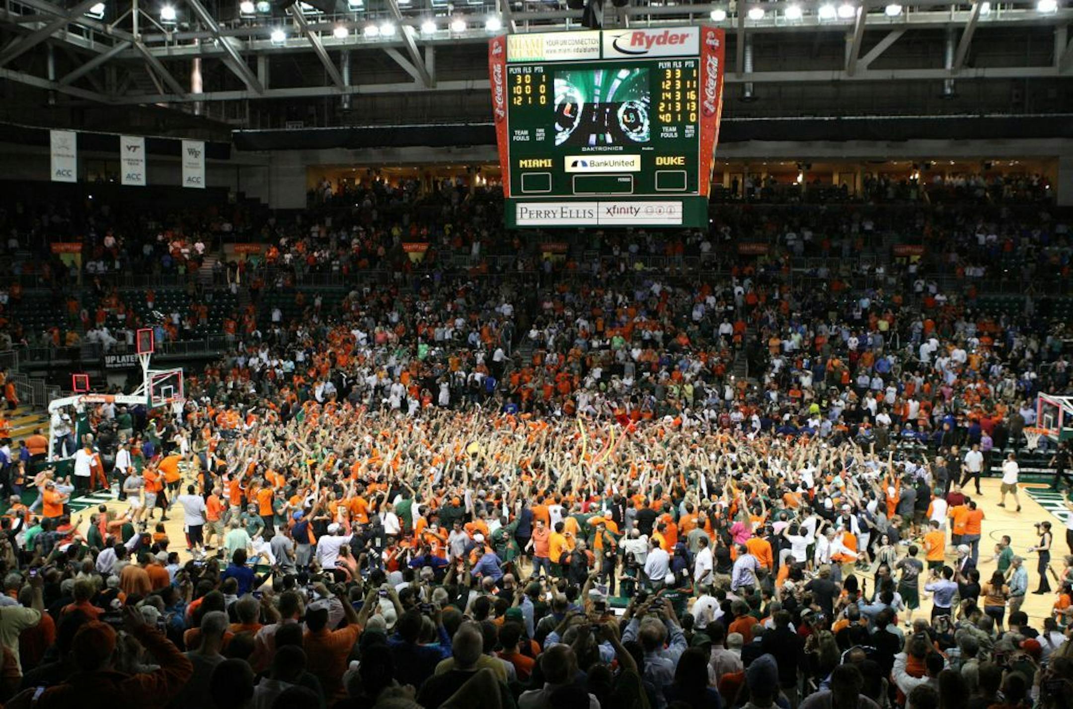 Miami fans storm the court at the end of a 90-63 thrashing of Duke at the BankUnited Center in Coral Gables, Florida, Wednesday, January 23, 2013. Miami defeated Duke, 90-63.
