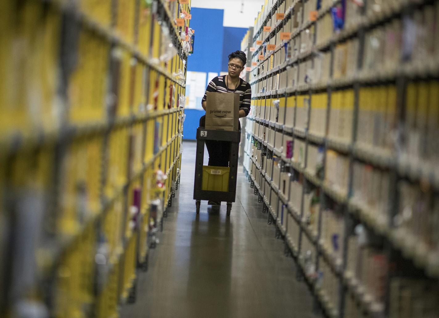 Dominique Miller, an associate at Amazon Prime Now hub, selected items for customers in Minneapolis on Thursday.