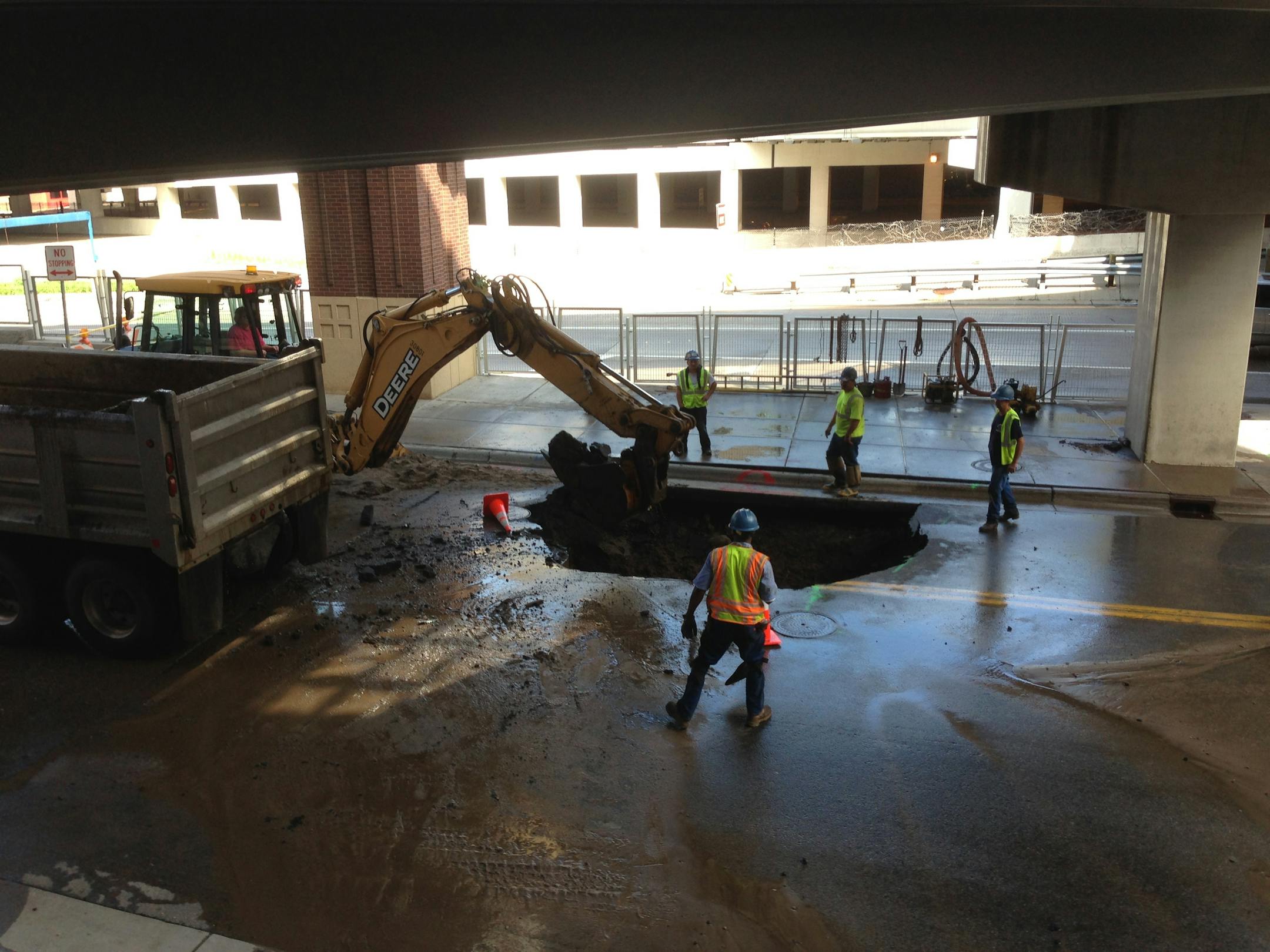 Workers repair a water main break near Target Center after officials shut down the ramps from eastbound 394 to both 6th and 4th Street in downtown Minneapolis due to flooding early Tuesday.