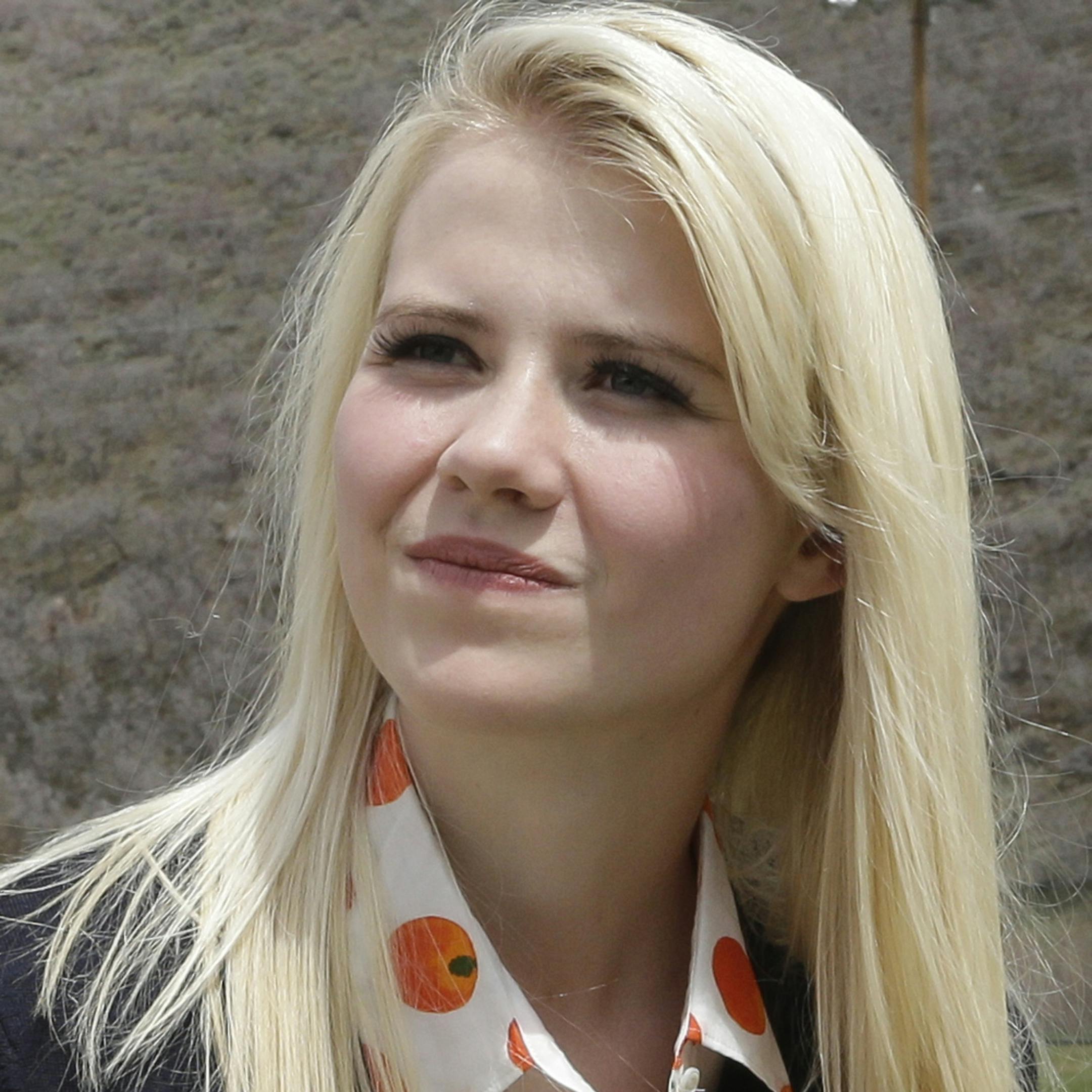 FILE - In this May 7, 2013, file photo, Elizabeth Smart talks with a reporter before an interview in Park City, Utah. More than a decade after her kidnapping and rescue grabbed national headlines, Smart is publishing a memoir of her ordeal. The 308 page book, titled "My Story," is being released by St. Martin's Press on Monday, Oct. 7, 2013. (AP Photo/Rick Bowmer, File)