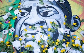 Yellow roses lay on the mural painted on the spot that George Floyd was murdered five years ago at George Floyd Square in Minneapolis on Sunday, May 2