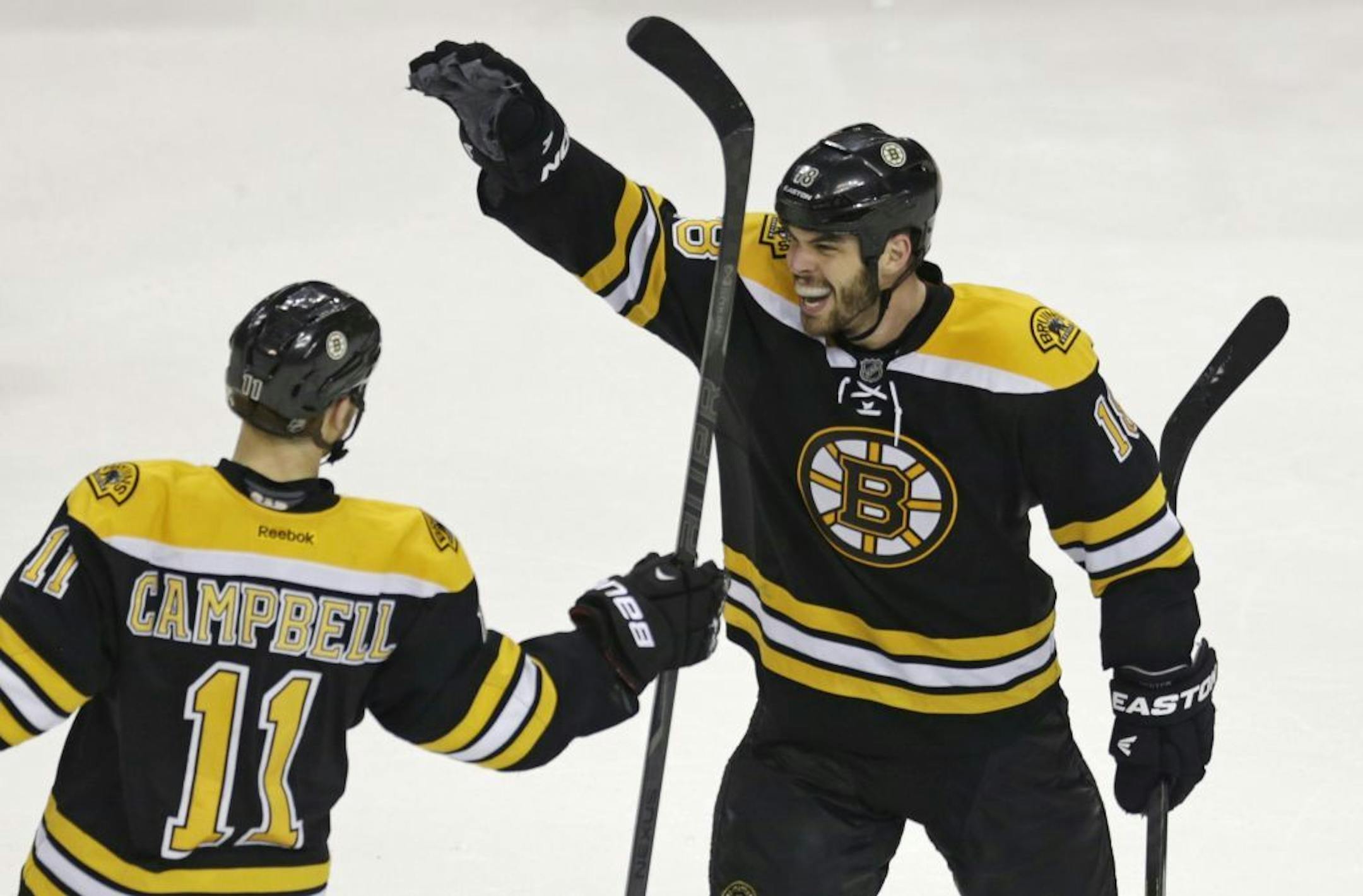 Boston Bruins center Gregory Campbell (11) is congratulated by teammate Nathan Horton, right, after his goal against the New York Rangers during the third period in Game 5 of the Eastern Conference semifinals