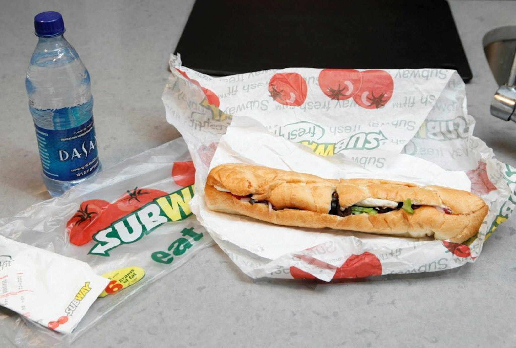This photo taken Aug. 11, 2009 shows a chicken breast sandwich and water from subway laid on Erik Trinidad's kitchen counter in New York. Trindad blogs about transforming fast food into fancy food; in this case he turns this sandwich into farfalle with chicken marinara sauce.