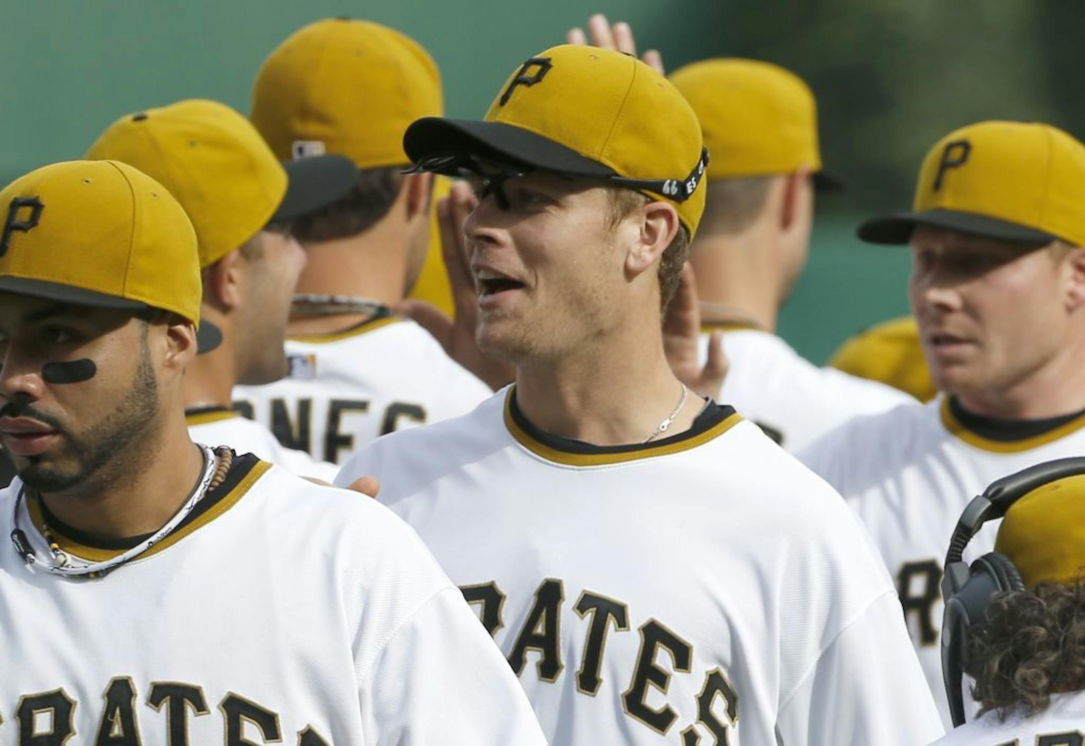 Pittsburgh Pirates' Justin Morneau, celebrates with teammates after the ninth inning of the baseball game on Sunday, Sept. 15, 2013, in Pittsburgh. Morneau drove in the go-ahead run as the Pirates won 3-2.