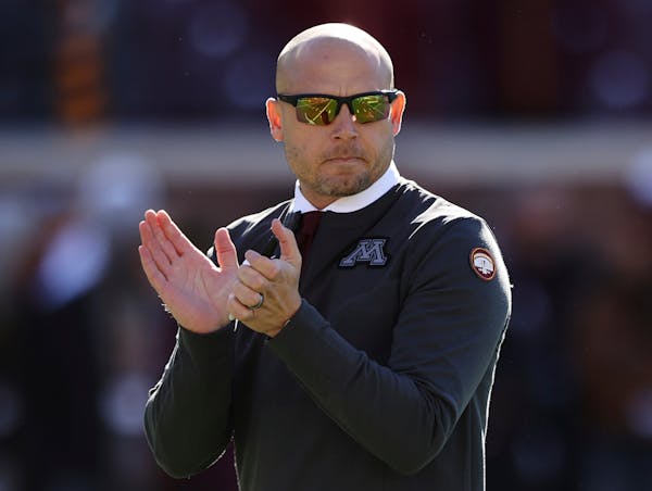Minnesota head coach P.J. Fleck cheers on players during pregame warmups in an NCAA college football game against Maryland, Saturday, Oct. 23, 2021, i