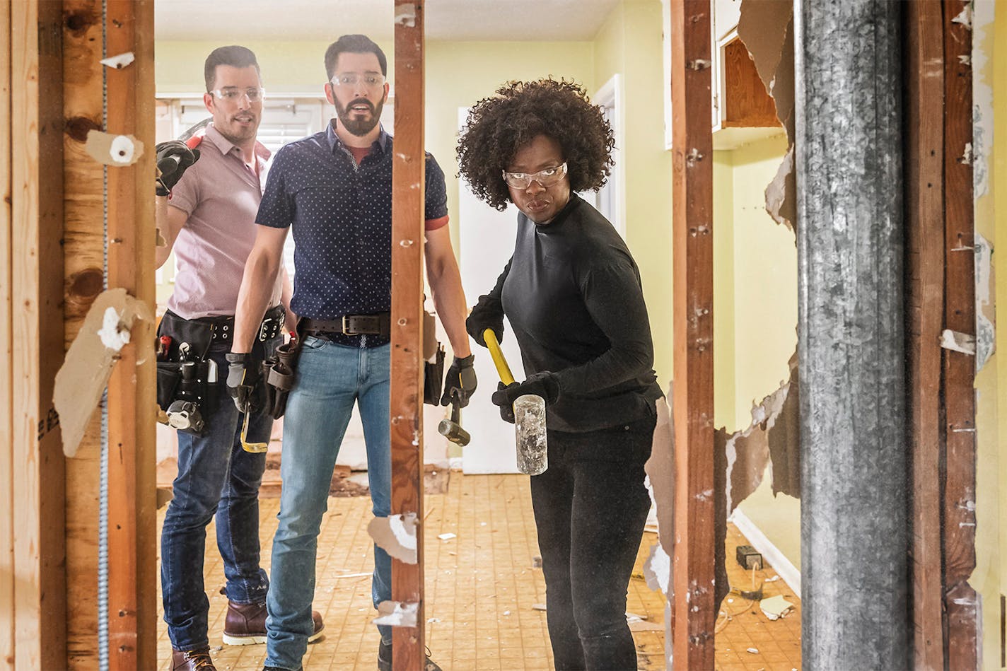 Viola Davis takes a sledgehammer to her friend Michelle O'Neill's house as Jonathan and Drew Scott watch, on HGTV's "Celebrity IOU."