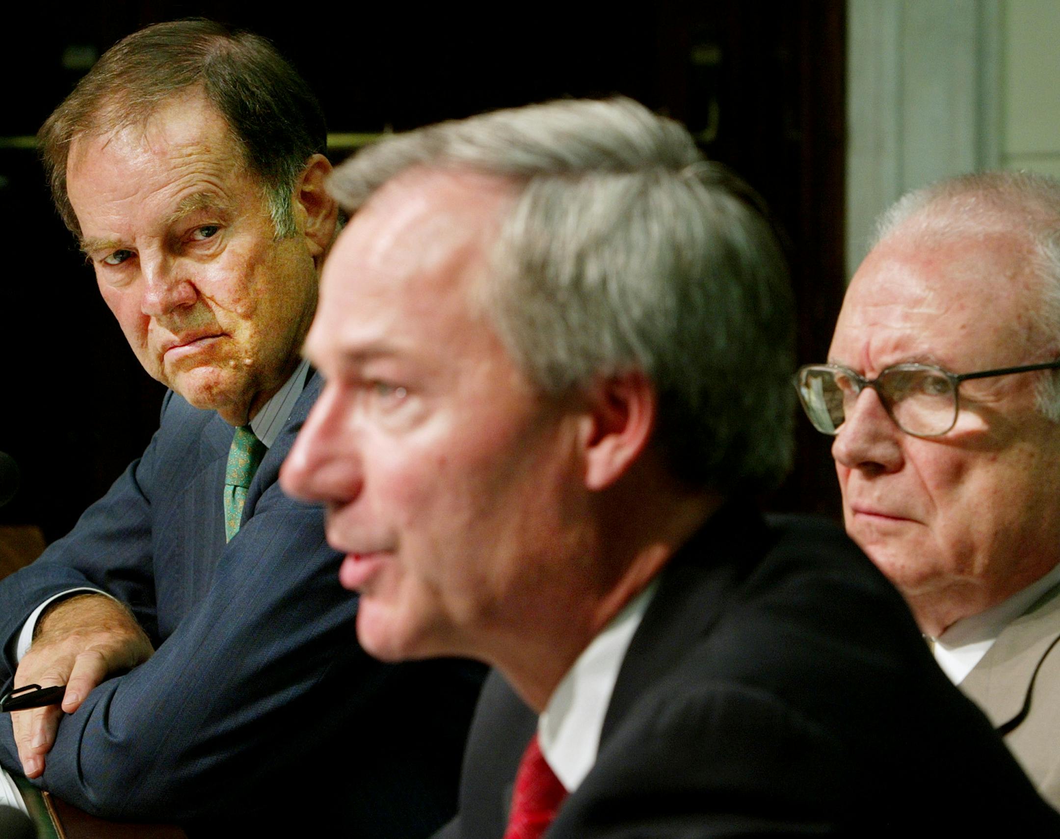 Sept. 11 commission Chairman former Gov. Thomas Kean, (L), and Vice Chairman Lee Hamilton (R) listen to Under Secretary of the Department of Homeland Security Asa Hutchinson as they appear before the Senate Commerce, Science and Transportation Committee on Capitol Hill, August 16, 2004. They testified before the committee to discuss the commission's recommendations for transportation security. REUTERS/Larry Downing