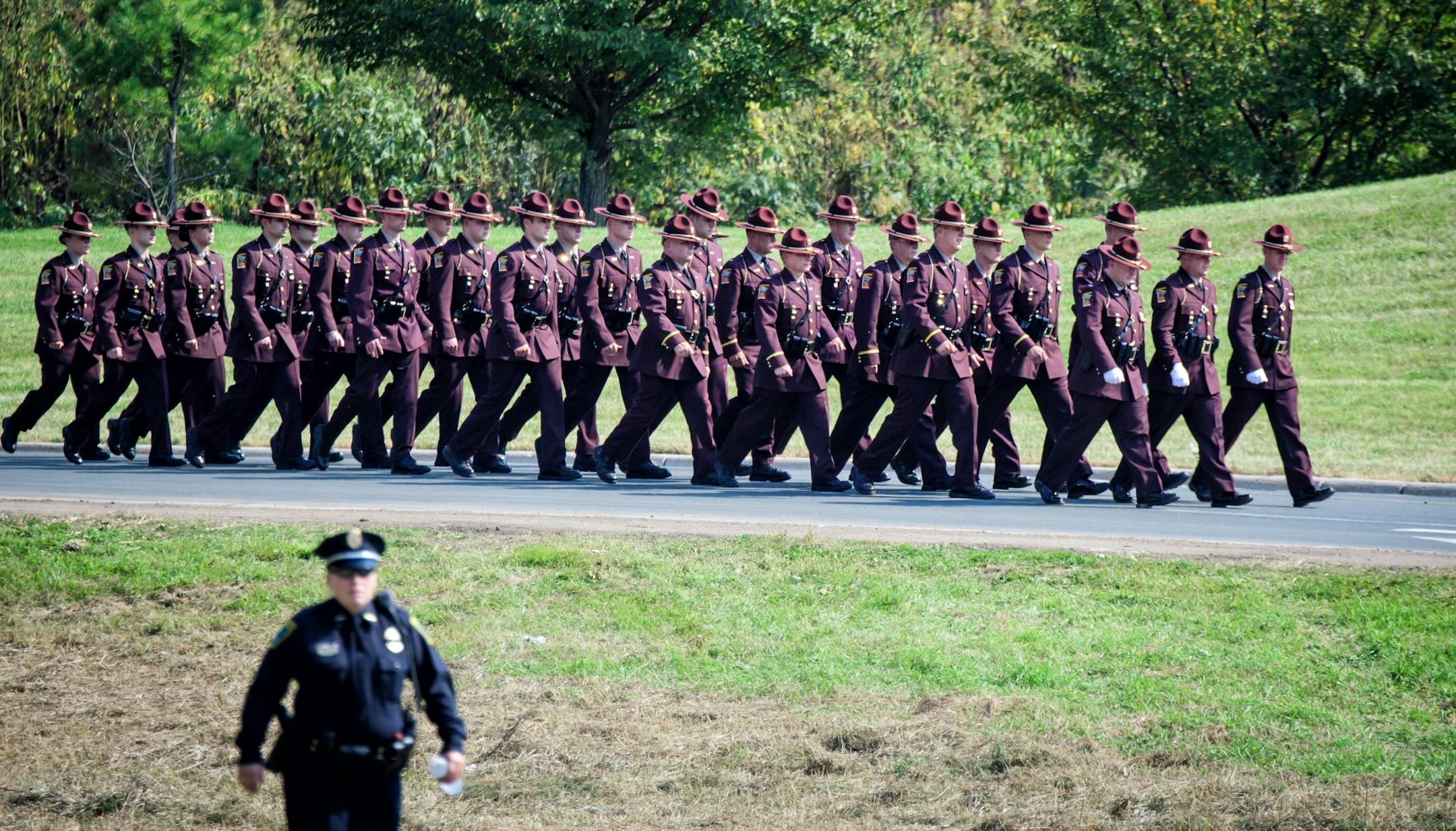 Minnesota State Troopers were among hundreds of law enforcement officers from Minnesota and across the country paid tribute to Officer William Mathews, here at his burial ceremony at Summit Park Cemetery.